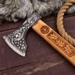 Hand-forged carbon steel Viking axe with rose wood handle and leather sheath.