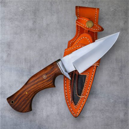 A classic handmade hunting knife by BCK, made from stainless steel, with a rosewood handle and a matching leather sheath.