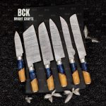 Handmade Damascus steel kitchen knife set with leather sheath.